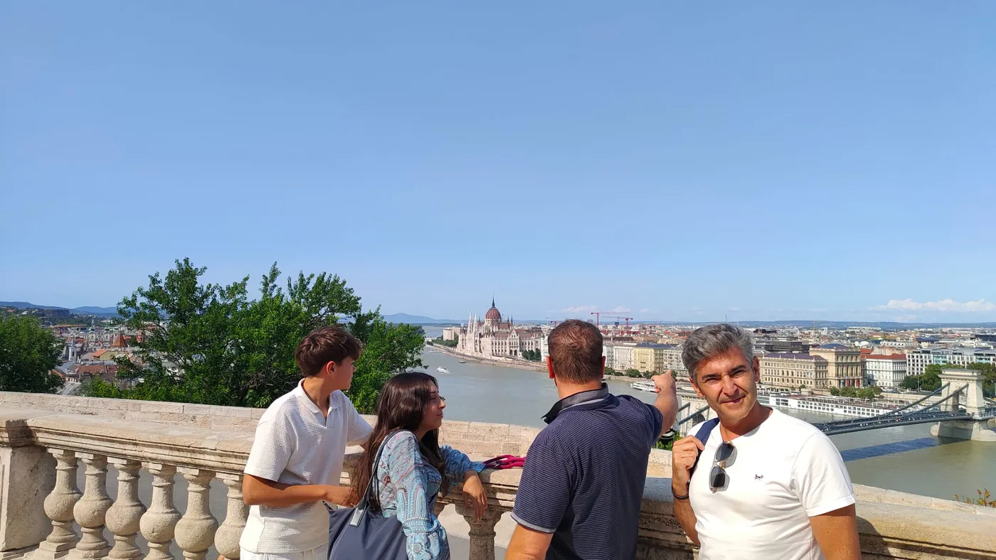 Guests on the Castle terrace with the Parliament and the Chain Bridge across the river behind them