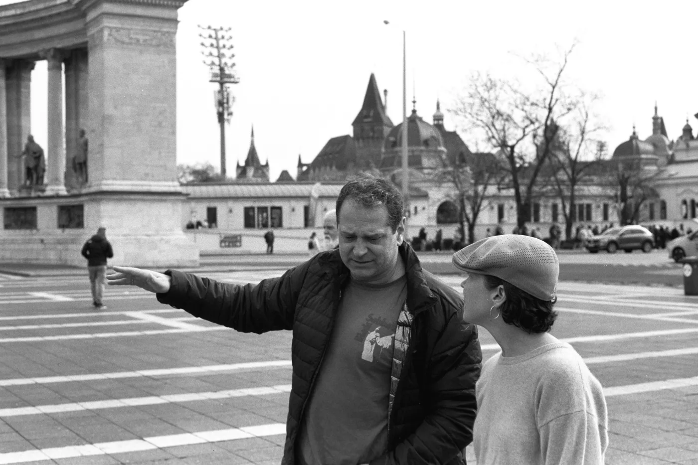 At Heroes' Square, the guide showing a guest where to look